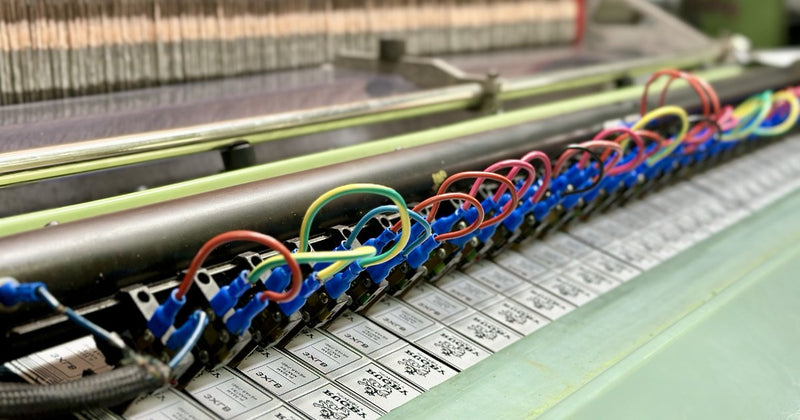 Woven labels being produced on a Jacquard loom at Labeloom's Shanghai factory